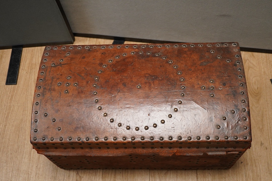 A 19th century leather and brass studded domed trunk, 65cm wide x 36cm high